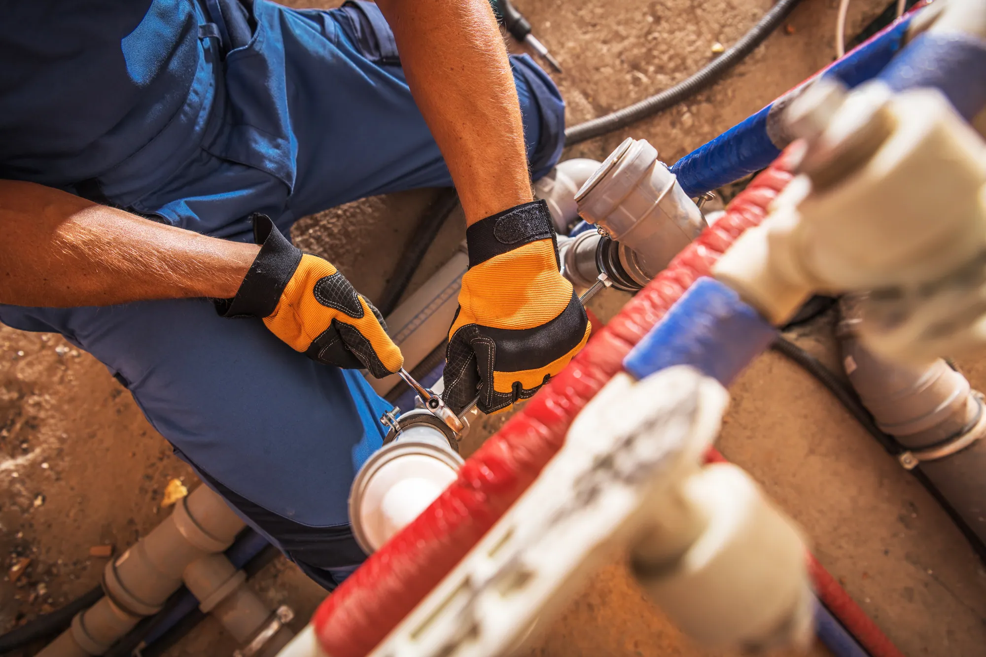 Professional plumber repairing pipes